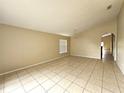 Bright living room featuring tiled flooring, neutral wall colors, and ample natural light at 928 Chanler Dr, Haines City, FL 33844