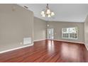 Expansive living room with hardwood floors, natural light, and an open layout at 9871 Nonacrest Dr, Orlando, FL 32832