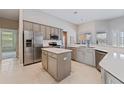 Bright and airy kitchen featuring stainless steel appliances, an island, and plenty of counter space at 10030 Chatham Oaks Ct, Orlando, FL 32836