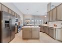 Spacious kitchen with stainless steel appliances, granite countertops, kitchen island and ample cabinet space at 10030 Chatham Oaks Ct, Orlando, FL 32836