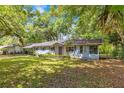 Inviting single-story home with mature trees, a well-kept lawn, and a convenient carport at 12046 Se 135Th Ave, Ocklawaha, FL 32179