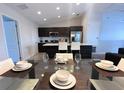 Dining area with open floor plan, modern table and chairs, and pendant lighting at 123 Kenny Blvd, Haines City, FL 33844