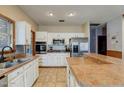 Bright kitchen with white cabinets, stainless steel appliances, breakfast bar, and a functional design at 13 Bass Lake Dr, Debary, FL 32713