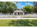 Inviting home featuring a well-maintained lawn, classic white picket fence, and a charming walkway to the front door at 1505 Magnolia Ave, Sanford, FL 32771