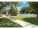 Expansive yard featuring a well-manicured lawn, white picket fence, and ample space for outdoor activities at 1505 Magnolia Ave, Sanford, FL 32771