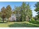 A beautiful two-story house with trees and lawn in the front yard at 16249 Se 162Nd Ct, Weirsdale, FL 32195