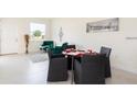 Cozy living room with table set for dining near large windows and comfortable seating at 1800 Coriander Dr, Kissimmee, FL 34759