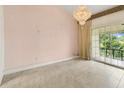 Vaulted living room featuring tile floors, a view of the exterior and a chandelier at 200 Maitland Ave # 122, Altamonte Springs, FL 32701