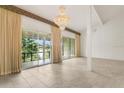 Bright living room showcasing tile floors, a chandelier, and views from the sliding glass doors at 200 Maitland Ave # 122, Altamonte Springs, FL 32701