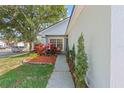 Beautifully landscaped front yard with walkway and decorative plants leading to the entrance at 202 Twisting Trl, Orlando, FL 32825