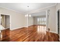 Spacious living area with hardwood flooring, bright natural light, and decorative columns at 2305 Edgewater Dr # 1509, Orlando, FL 32804