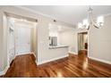 Open living area with hardwood floors, modern lighting, and sight lines to kitchen at 2305 Edgewater Dr # 1509, Orlando, FL 32804
