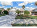 Inviting one-story home with a two-car garage, front porch, and well-maintained landscaping at 25 Reflections Village Dr, Ormond Beach, FL 32174
