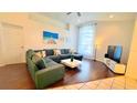 Inviting living room features a plush sectional sofa, a modern coffee table, and a large window at 3129 Arrow Dr, Kissimmee, FL 34746