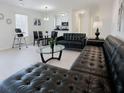 Open-concept living space seamlessly integrates a cozy seating area with a dining space and a glimpse of the kitchen at 3260 Pinto Dr, Kissimmee, FL 34746