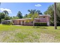 A beautiful home surrounded by mature trees and landscaping at 360 W University Ave, Orange City, FL 32763