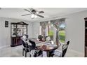 Bright dining room features a dark wood display case, dining table with seating for six, and large window at 7 Madeira Ave, Orlando, FL 32825