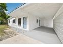 The carport leads to the front door and features decorative concrete blocks for semi-privacy at 7301 Armstrong Rd, Orlando, FL 32810