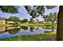 Community pond reflecting the sky and surrounding homes in this peaceful neighborhood at 830 Airport Rd # 115, Port Orange, FL 32128