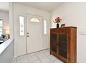 Bright entryway featuring tile flooring, and a decorative cabinet at 8625 Shady Glen Dr, Orlando, FL 32819