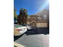 Exterior view of condo with garage, private balcony, and manicured landscaping under clear skies at 8801 Villa View Cir # 207, Orlando, FL 32821