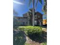 A beautiful exterior of a two story condo with private balconies and landscaped front yard at 8801 Villa View Cir # 207, Orlando, FL 32821