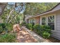 Inviting exterior featuring a charming walkway and lush landscaping at 921 Torchwood Dr, Deland, FL 32724