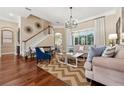 Cozy living room with hardwood floors, natural light, stylish decor, and comfortable seating at 968 Ashton Oaks Cir, Lakeland, FL 33813