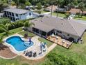 Aerial view of a private backyard oasis featuring a pool, deck, screened-in patio, and lush landscaping at 986 Stonewood Ln, Maitland, FL 32751