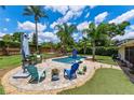 Inviting backyard pool area with ample seating, lush landscaping, and a serene outdoor living space at 986 Stonewood Ln, Maitland, FL 32751