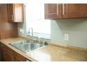 A view of the kitchen sink, countertop, and cabinets at 110 N Alderwood St, Winter Springs, FL 32708