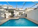 Inviting screened-in pool area with patio furniture, perfect for outdoor relaxation and entertaining at 1128 Challenge Dr, Davenport, FL 33896