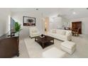 Bright living room with tile flooring, vaulted ceilings, and sophisticated neutral decor at 1243 Tangerine Cir, Lady Lake, FL 32159