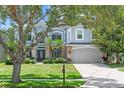 Charming two-story home with a manicured lawn, complemented by lush landscaping and a two car garage at 1467 Selbydon Way, Winter Garden, FL 34787