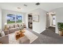 Comfortable living room with plush carpet, modern furniture, and bright natural light at 1623 Crestlawn Ave, Orlando, FL 32811