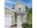 Inviting front entrance with a classic white door, manicured landscaping, and neutral color scheme at 164 14Th Ave, Longwood, FL 32750