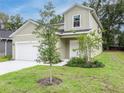 Charming home featuring a two-car garage, manicured lawn, and classic architectural details at 164 14Th Ave, Longwood, FL 32750
