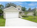 Charming home featuring a two-car garage, manicured lawn, and classic architectural details at 164 14Th Ave, Longwood, FL 32750
