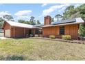 Exterior of a cozy single-story home, with solar panels and a well-manicured front yard at 175 Cliff St, Deland, FL 32720