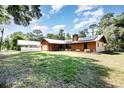 Home exterior with spacious lawn and carport, showing the home's position on a roomy lot at 175 Cliff St, Deland, FL 32720