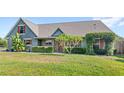 Inviting single-story home showcasing a well-manicured lawn and decorative shrubbery at 1880 Lorraine Way, St Cloud, FL 34769