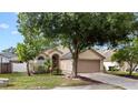 Charming single-story home featuring a well-manicured lawn, arched entry, and attached two-car garage at 1919 River Park Blvd, Orlando, FL 32817