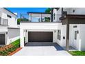 Modern two-story home with a balcony, covered parking, and fresh landscaping at 21 N Hampton Ave # Lot 2, Orlando, FL 32803