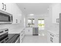 Bright kitchen featuring white cabinets, stainless steel appliances, and modern countertops at 21 N Hampton Ave # Lot 2, Orlando, FL 32803