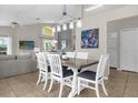 Open-concept dining area with modern lighting, vaulted ceiling, and seamless transition to the living spaces at 217 Holborn Loop, Davenport, FL 33897