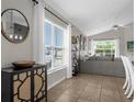 Bright living room featuring neutral decor, tile flooring, and a large window overlooking the outdoors at 217 Holborn Loop, Davenport, FL 33897