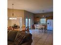 Eat-in kitchen with tile flooring, oak cabinets, white appliances, and an adjacent dining area at 225 Vista Dr, Davenport, FL 33897