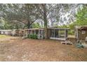 Exterior view of the home featuring a screened porch perfect for enjoying the outdoors at 24089 Ne 152Nd Ln, Fort Mc Coy, FL 32134