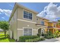 Charming side view of a two-story home featuring lush landscaping and a glimpse of the serene lake at 3055 Beach Palm Ave, Kissimmee, FL 34747