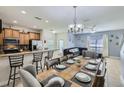 Open concept living area with a kitchen bar, tile flooring, and a dining and Gathering room combo at 3055 Beach Palm Ave, Kissimmee, FL 34747